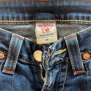 True Religion Joey jeans. Size 26. Orange stitching on dark denim.